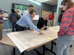 Project staff explain construction plans to open house attendees