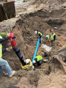 Crews install a hydrant on 4th Street.