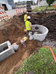 Crews install storm sewer catch basin and manhole on 4th Street