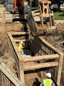 Crews set a sanitary sewer manhole at 12th Avenue and 5th Street