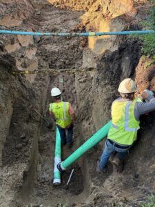 Crews install sanitary sewer service on 5th Street.