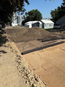Crews lay road base for 4th Street.