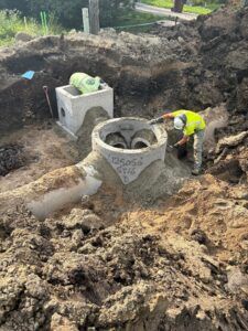 Crews install a storm sewer manhole on 8th Avenue.