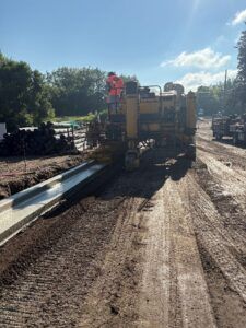 Crews install concrete curb on 4th Street.