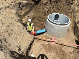 A construction crew member works on water utilities.