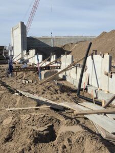 Retaining wall work continues.